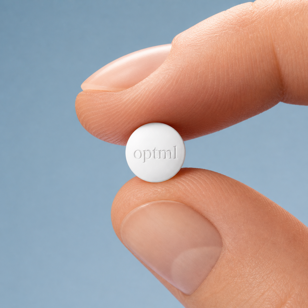 Bioidentical 17β-estradiol tablet held between fingers, OPTML